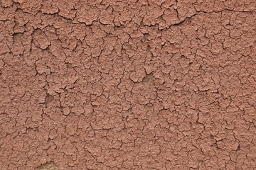 brick-brown putty is cracking and moving away from the surface