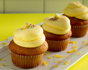 Three Yellow Cupcakes with Lemon Frosting