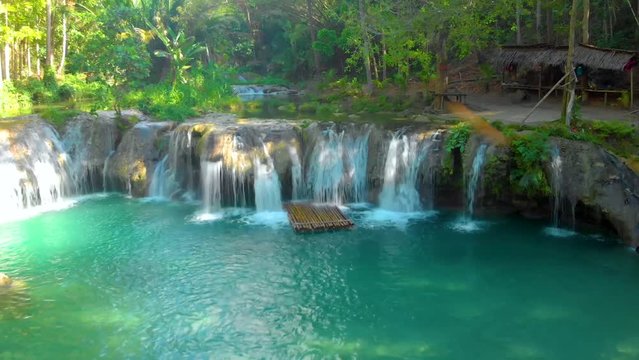 Water flowing from Cambugahay Falls into natural turquoise pool in Siquijor Island, the Philippines. Waterfall Landscape