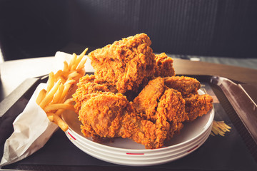 Close-up Fried chicken,freshfast on plate with fried chicken blur background,Woman eating fried chicken,Hungry,diet,Fat food,healthy food