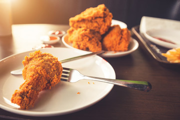 Close-up Fried chicken,freshfast on plate with fried chicken blur background,Woman eating fried chicken,Hungry,diet,Fat food,healthy food