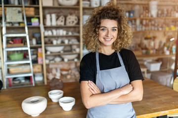 Portrait of woman pottery artist in art studio