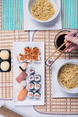top view of Different rolls background. Traditional sushi. Delicious japanese food.various sushi on white plate