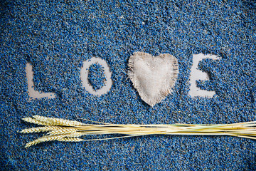 inscription love made by lavender on craft background, blue letter from lavender