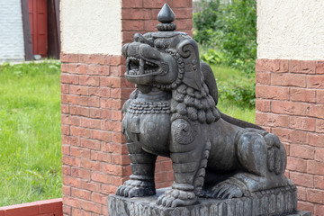 Stone traditional guard lions near the temple in the ethnic centre