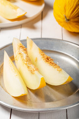 Sweet yellow fresh melon on wooden table