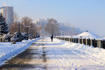 Winter street covered with snow. Snowy Embankment on a frosty day. View of the city of Dnipro,...