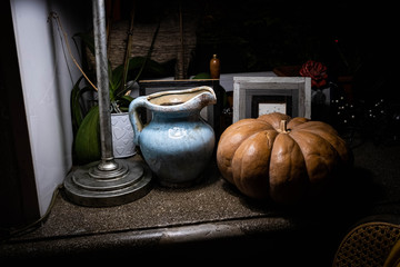 pumpkin and jug are on the windowsill