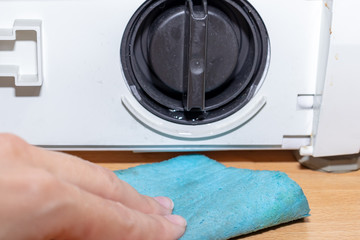 Broken pump of washing machine's caused by dirty clogged drain pump filter close up, clean and...