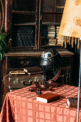 on the table lies the pilot's helmet, a toy airplane made of wood