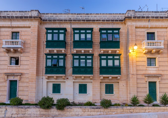 Fototapeta na wymiar Valletta. Traditional balconies on the facades of houses.