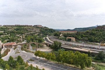 Aerial view of roads, roundabout traffic and railroads in Spain