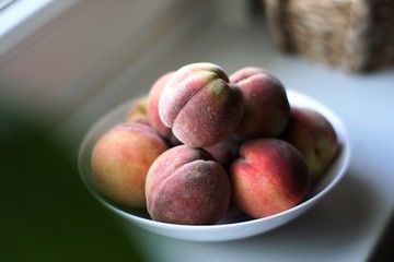 Fresh peaches. still life on the windowsill. natural light from the window.
