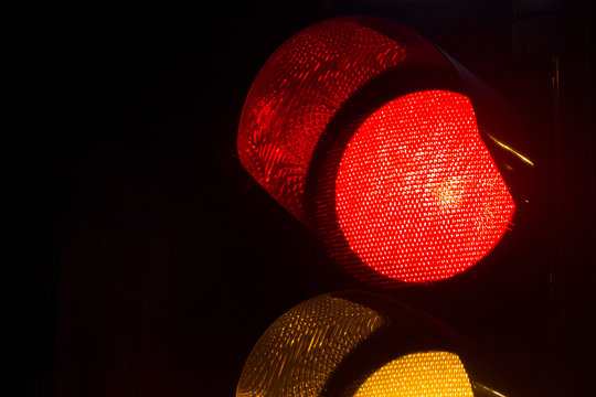 Closeup of a traffic light by night in Israel.
