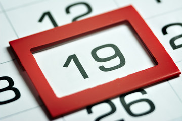 nineteenth day of the month highlighted on the calendar with a red frame close-up macro, mark on the calendar, nineteenth date