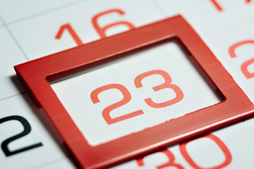 twenty-third day of the month highlighted on the calendar with a red frame close-up macro, mark on...
