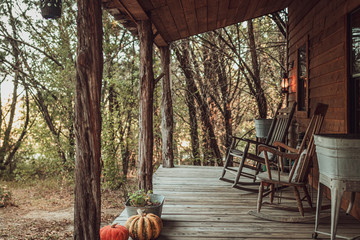 Front porch of a cabin in the woods wide