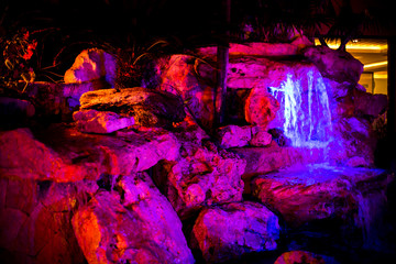 Neon Cave Rocks and Stream of Water
