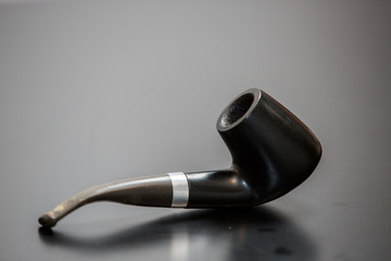 pipe on a black wooden background