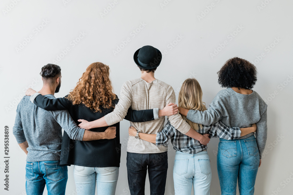 Canvas Prints rear view of row of young casual college friends embracing each other