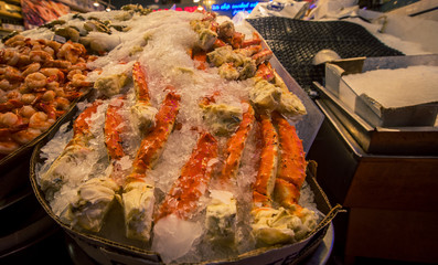 crabs legs on ice at a fish market