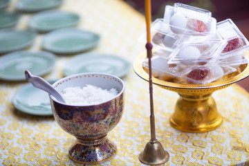 Offer food to monk. Groom give alms food to a Buddhist monk in traditional thai wedding ceremony. Hand while put food offerings in a Buddhist monk's alms bowl.Buddhists offer food in bowls.
