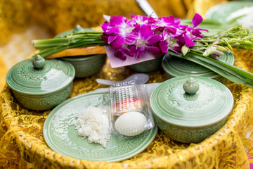 Offer food to monk. Groom give alms food to a Buddhist monk in traditional thai wedding ceremony. Hand while put food offerings in a Buddhist monk's alms bowl.Buddhists offer food in bowls.