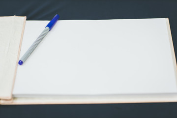 Wedding album, blank page, guest list, to do list.still life photography concept by memory and notebook.Notepad book.Notebook and asters on canvas background.soft and blur style for background.