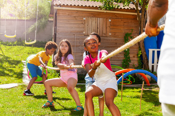 Rope pulling action game kids in diverse group