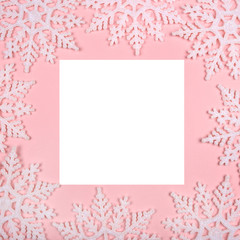 Winter pattern made of snowflakes and on pink background. Christmas concept. Flat lay. Copy space for your text.