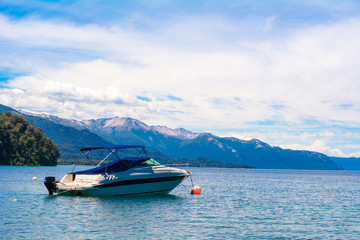 Boats sailing on calm lake water.