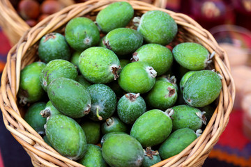 Green feijoa fruits laying in the basket at the market in Tbilisi Georgia.