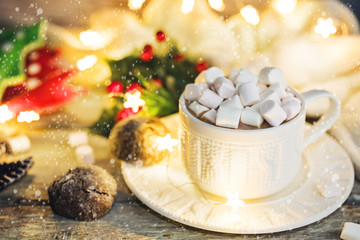 Christmas holidays wood background with Cup of Cocoa with marshmallow, luminous garland and cookie