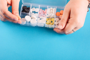 hand showing medicine box with pills