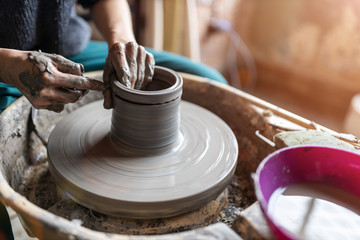 Woman making ceramic work with potter's wheel
