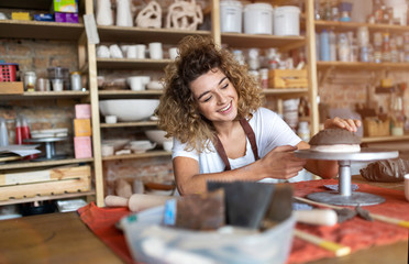 Woman pottery artist makes ceramics from clay