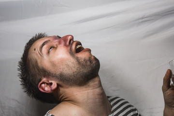 Obraz premium male alcoholism. drinking father, a man drinks vodka. feeling unwell. assault, booze at home. stop alcohol