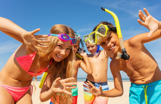 Kids waving hands wearing scuba snorkeling masks
