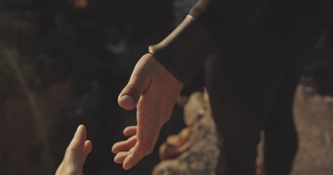 Man giving hand to a woman, filmed on cinematic camera, 12 bit color
