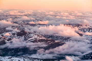 Aerial view of snowy landscape in winter with mountains and lakes in Norway at sunset