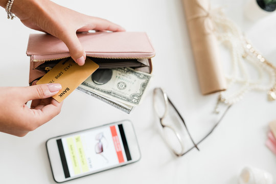 Hands Of Young Woman Holding Leather Wallet With Dollar Bills And Plastic Card