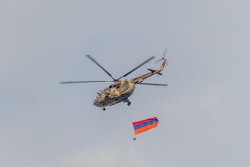 YEREVAN, ARMENIA - JULY 5, 2017: Helicopter carrying the national flag of Armenia during the celebrations of the Constitution Day and Day of State Symbols in Yerevan, capital of Armenia