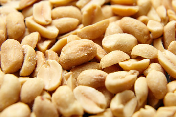 Roasted peeled peanuts closeup, salty beer snack