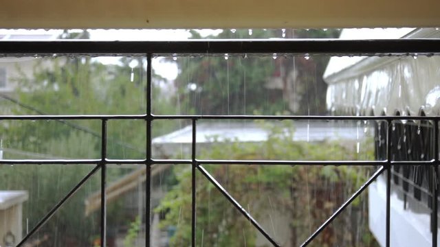 Rain falling down on balcony rail isolated