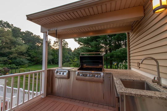 outdoor kitchen with grill, sink and granite countertop