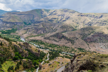 Fototapeta na wymiar View of Mtkvari river from the cave monastery Vanis Kvabebi carved into a cliff, Georgia