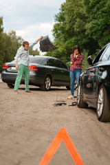 Car accident on road, man and woman are sorted out