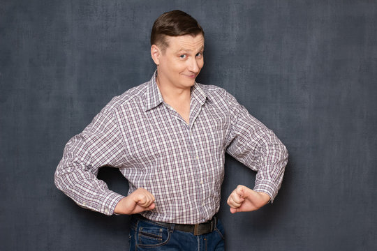 Portrait of funny happy man posing like confident macho