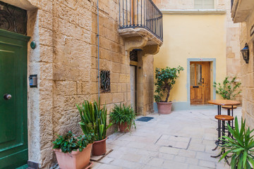 Fototapeta na wymiar Typical narrow street in Birgu town, Malta