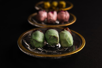 various dates on shiny crystal plates with golden design